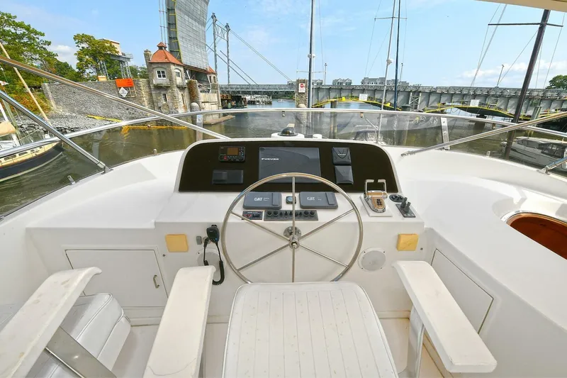 Symmetry Yacht Photos Pics Helm of 2002 Grand Alaskan Flushdeck yacht with steering wheel and navigation equipment.