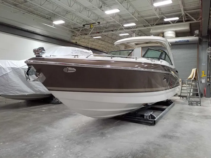  Yacht Photos Pics 2019 Formula 350 Crossover Bowrider OB in a warehouse setting.