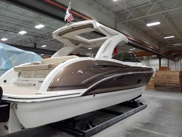  Yacht Photos Pics 2019 Formula 350 Crossover Bowrider OB in warehouse, sleek design, American flag displayed.