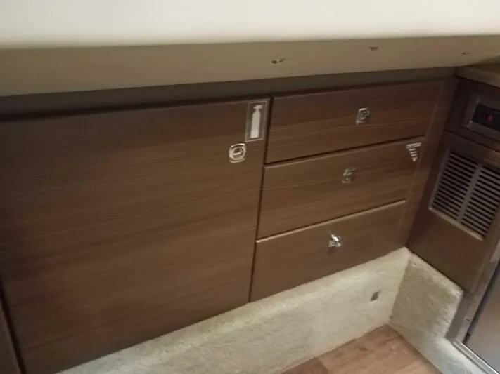  Yacht Photos Pics 2019 Formula 350 Crossover Bowrider OB interior cabinetry with wood finish and storage drawers.