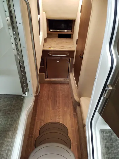  Yacht Photos Pics 2019 Formula 350 Crossover Bowrider OB interior with kitchenette and wood flooring.