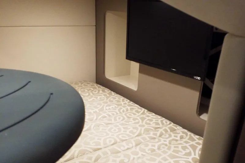  Yacht Photos Pics 2019 Formula 350 Crossover Bowrider OB cabin interior with TV and patterned bedding.