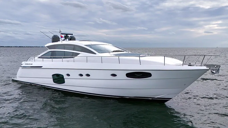  Yacht Photos Pics Luxury 2020 Pershing 62 yacht cruising on open water under cloudy skies.