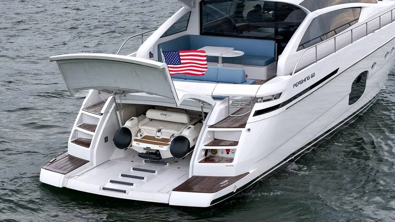  Yacht Photos Pics Luxury Pershing 62 yacht, 2020 model, with open garage and American flag.