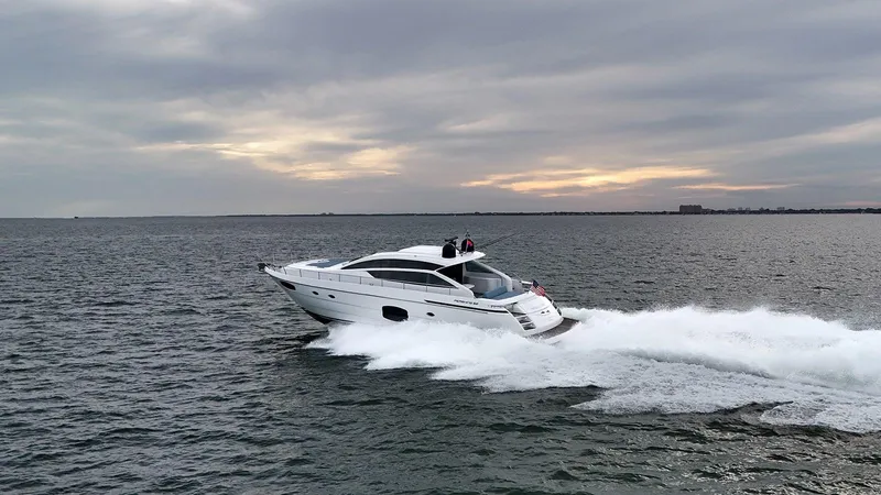  Yacht Photos Pics 2020 Pershing 62 yacht cruising on open water at sunset.