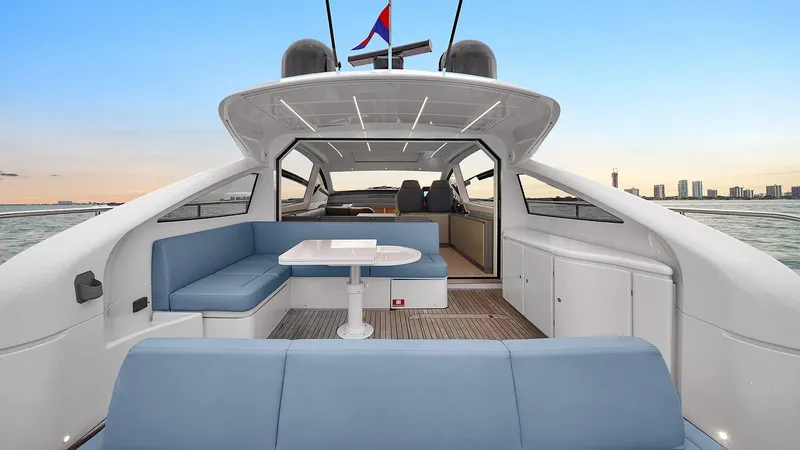  Yacht Photos Pics 2020 Pershing 62 yacht interior with blue seating and table, ocean view.