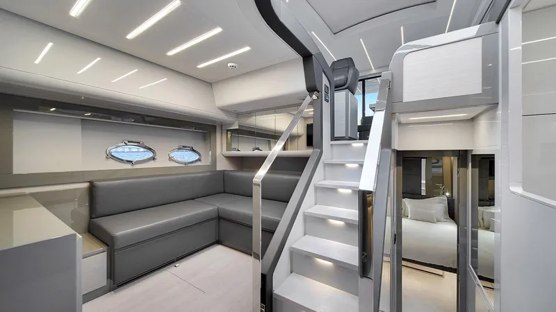  Yacht Photos Pics Luxurious interior of 2020 Pershing 62 yacht with modern seating and sleek staircase.