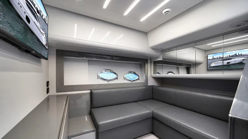  Yacht Photos Pics Luxurious interior of 2020 Pershing 62 yacht with modern seating and porthole windows.