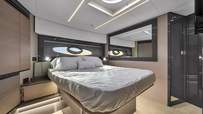  Yacht Photos Pics Luxurious bedroom interior of 2020 Pershing 62 yacht with modern design and elegant lighting.
