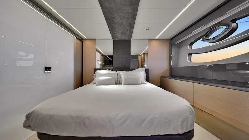  Yacht Photos Pics Luxurious bedroom interior of 2020 Pershing 62 yacht with modern design and large window.