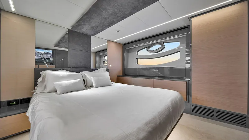  Yacht Photos Pics Luxurious bedroom interior of 2020 Pershing 62 yacht with modern design and elegant furnishings.
