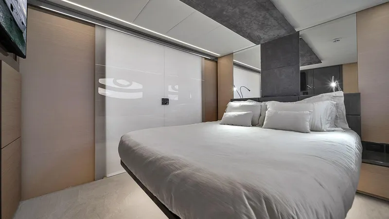  Yacht Photos Pics Luxurious bedroom interior on a 2020 Pershing 62 yacht, featuring modern design and elegant furnishings.