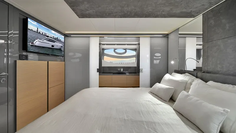  Yacht Photos Pics Luxurious bedroom interior of 2020 Pershing 62 yacht with modern design and large window.