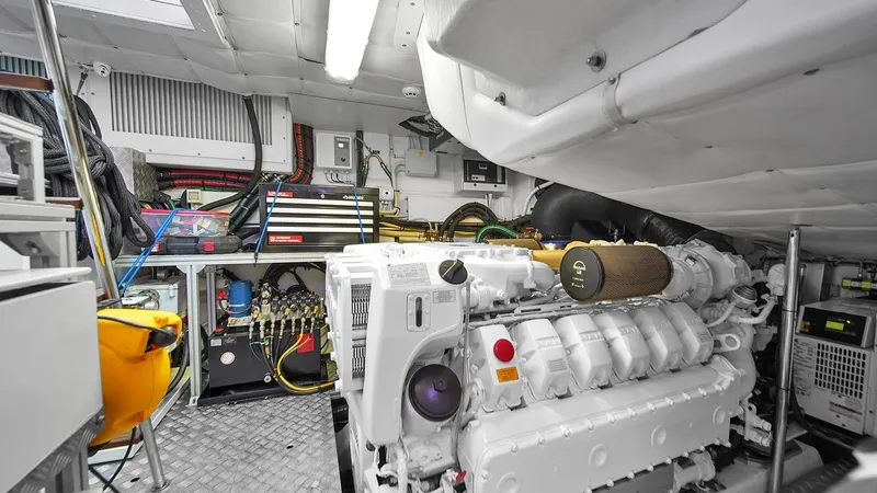  Yacht Photos Pics Engine room of a 2020 Pershing 62 yacht, featuring organized tools and equipment.