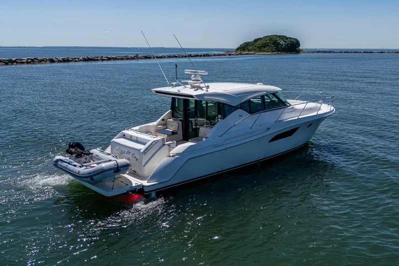  Yacht Photos Pics 2020 Tiara Yachts C44 Coupe cruising on open water, showcasing sleek design and luxury.
