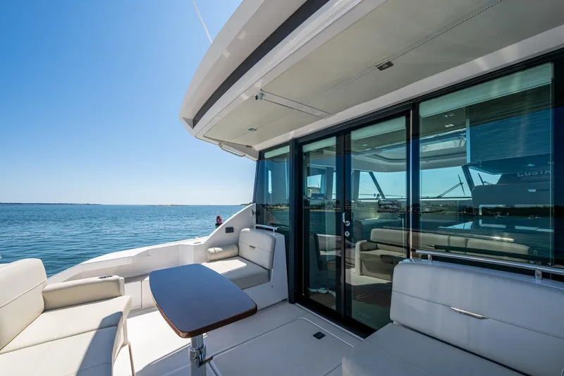  Yacht Photos Pics 2020 Tiara Yachts C44 Coupe deck with seating, ocean view, and sliding glass doors.