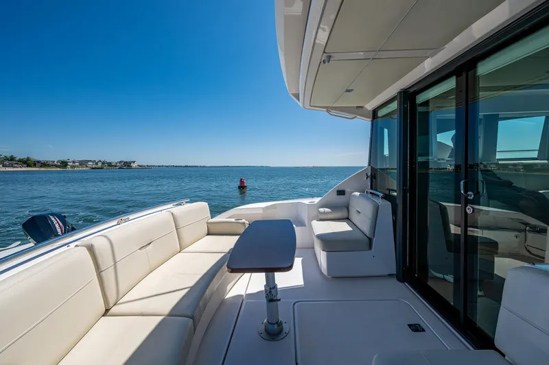  Yacht Photos Pics 2020 Tiara Yachts C44 Coupe deck with seating, ocean view, and clear blue sky.