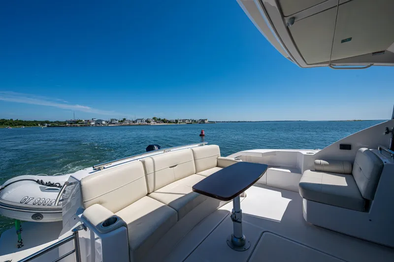  Yacht Photos Pics Luxurious 2020 Tiara Yachts C44 Coupe with elegant seating, cruising on serene waters.