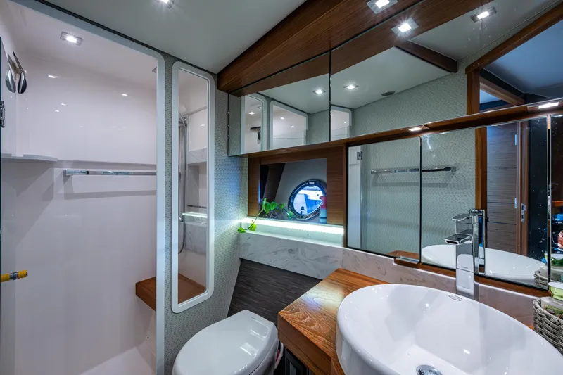  Yacht Photos Pics Luxurious bathroom interior of 2020 Tiara Yachts C44 Coupe with modern fixtures and elegant design.