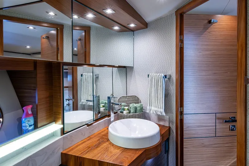  Yacht Photos Pics Luxurious bathroom interior of 2020 Tiara Yachts C44 Coupe with modern fixtures and wooden accents.