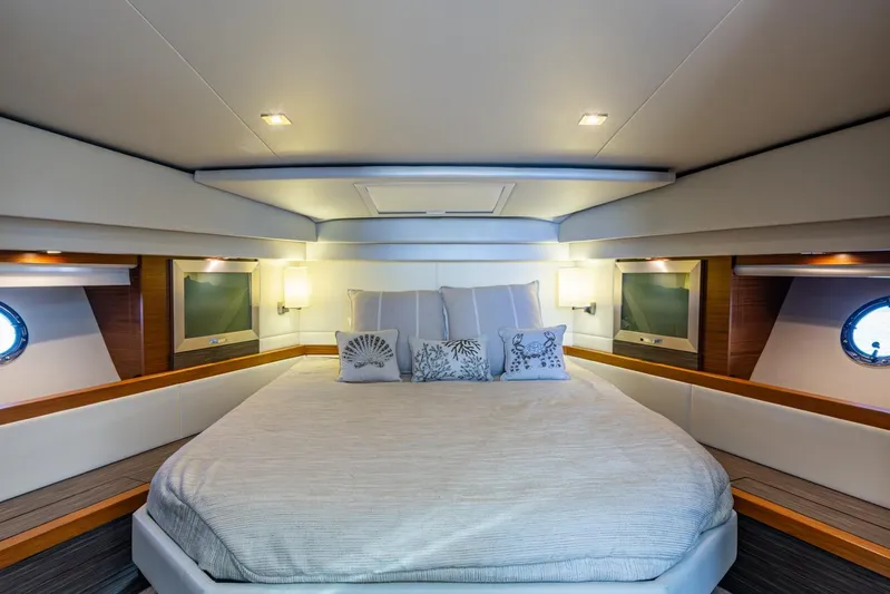  Yacht Photos Pics Luxurious 2020 Tiara Yachts C44 Coupe bedroom with elegant decor and ambient lighting.