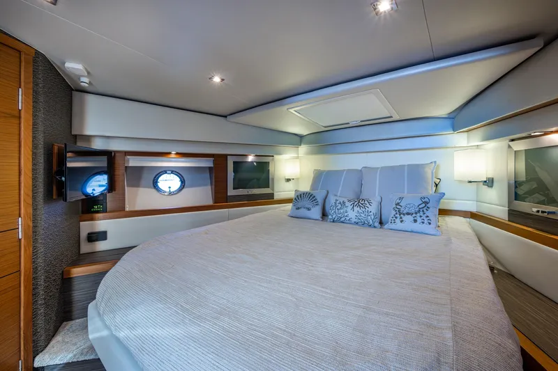  Yacht Photos Pics Luxurious bedroom interior of 2020 Tiara Yachts C44 Coupe with elegant decor.