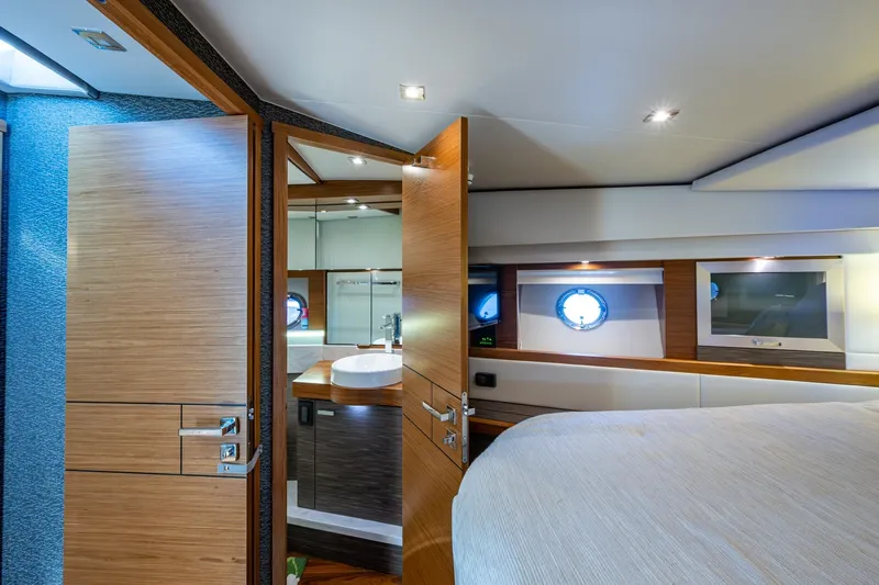  Yacht Photos Pics Luxurious interior of 2020 Tiara Yachts C44 Coupe, featuring a modern bedroom and bathroom.