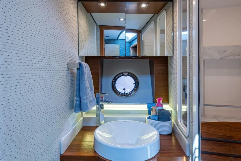  Yacht Photos Pics Luxurious bathroom in 2020 Tiara Yachts C44 Coupe with modern fixtures and porthole window.