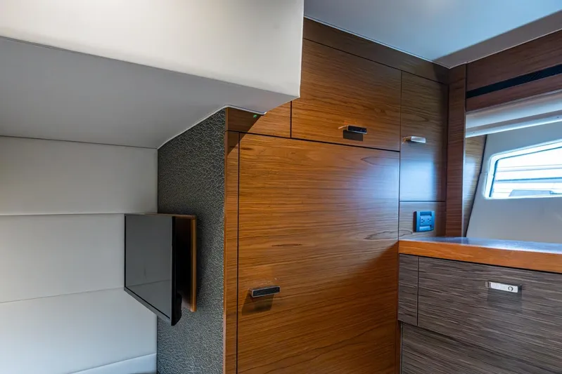  Yacht Photos Pics Interior of 2020 Tiara Yachts C44 Coupe, featuring sleek wood cabinetry and modern design.