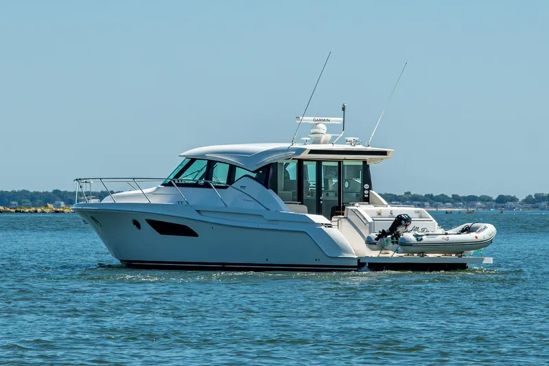  Yacht Photos Pics 2020 Tiara Yachts C44 Coupe cruising on open water.