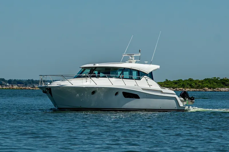  Yacht Photos Pics 2020 Tiara Yachts C44 Coupe cruising on open water.