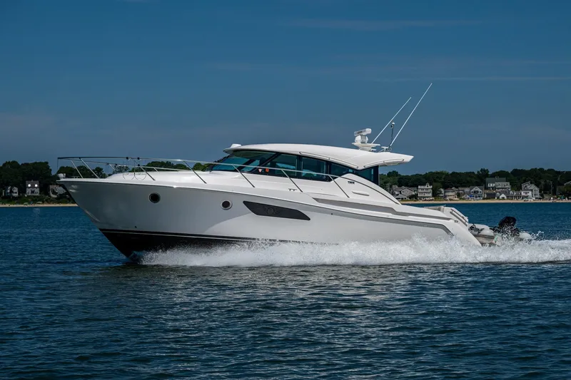  Yacht Photos Pics 2020 Tiara Yachts C44 Coupe cruising on water, showcasing sleek design and luxury.