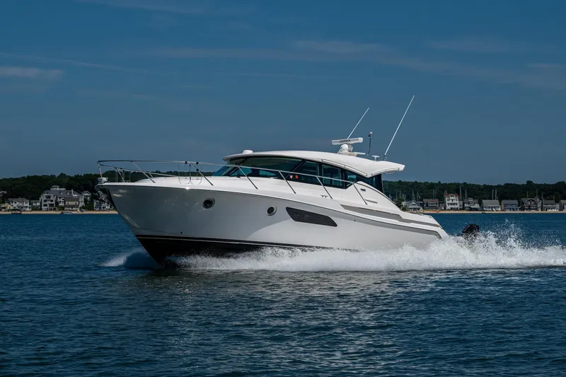  Yacht Photos Pics 2020 Tiara Yachts C44 Coupe cruising on open water, showcasing sleek design and performance.