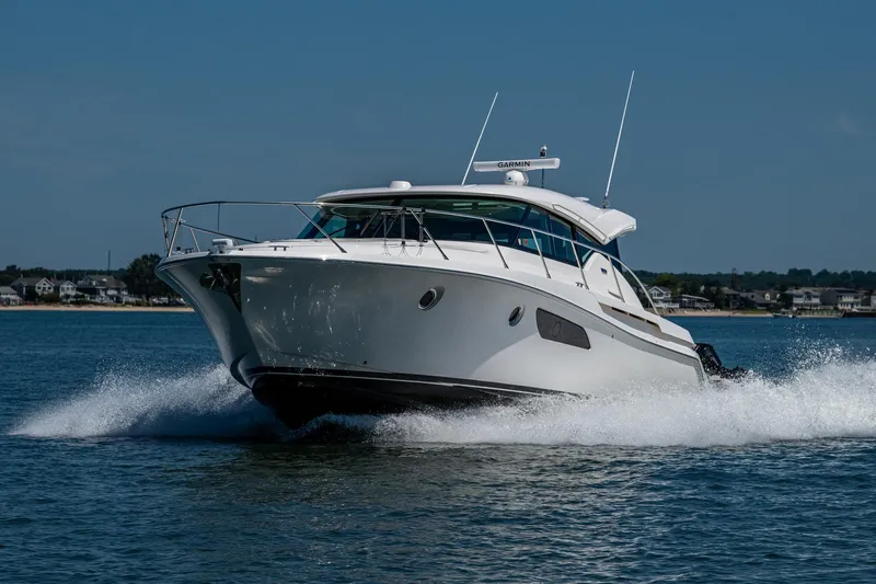  Yacht Photos Pics 2020 Tiara Yachts C44 Coupe cruising on open water, showcasing sleek design and performance.