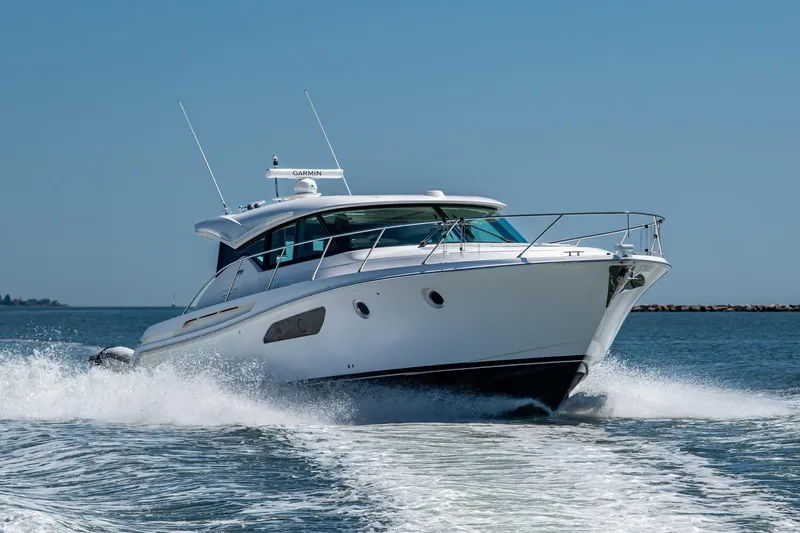  Yacht Photos Pics 2020 Tiara Yachts C44 Coupe cruising on open water, showcasing sleek design and performance.