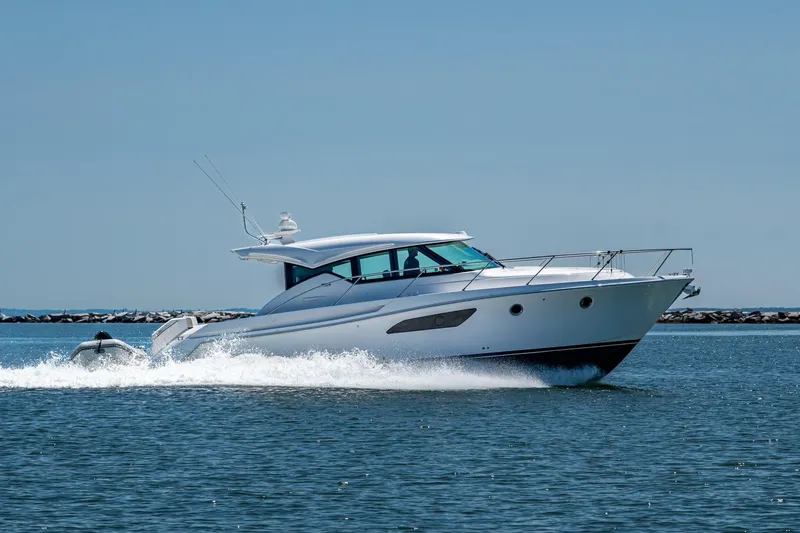  Yacht Photos Pics 2020 Tiara Yachts C44 Coupe cruising on open water.