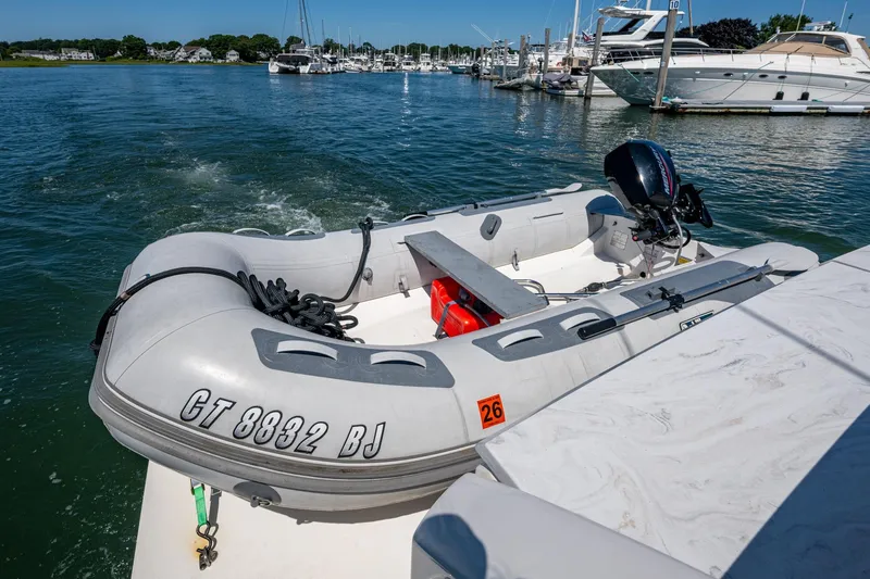  Yacht Photos Pics Inflatable dinghy with outboard motor on Tiara Yachts C44 Coupe, 2020 model, docked in marina.
