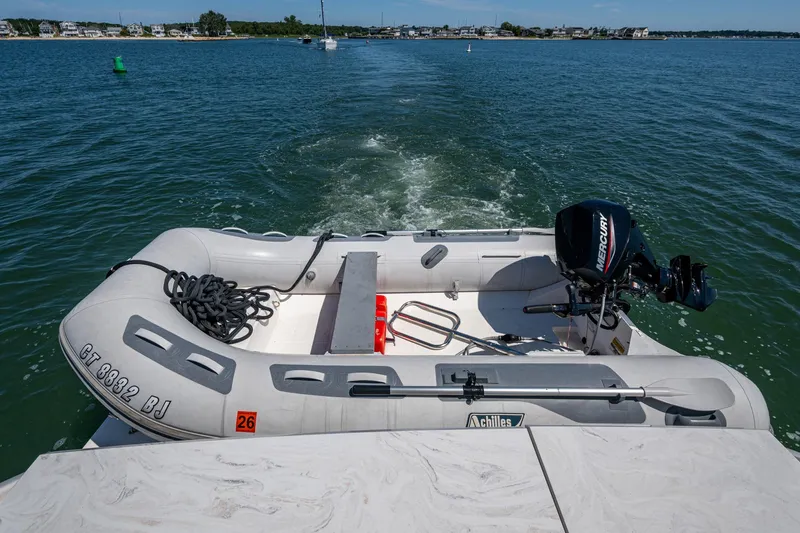  Yacht Photos Pics 2020 Tiara Yachts C44 Coupe with inflatable boat and Mercury motor on water.