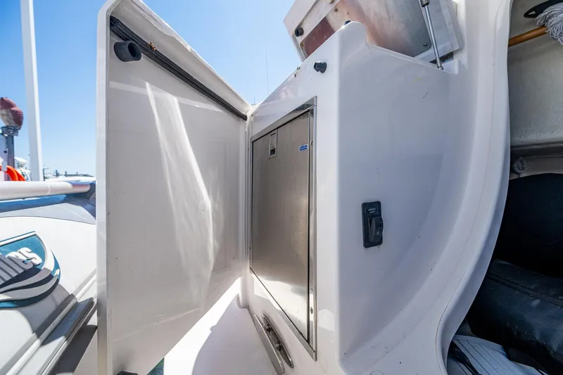  Yacht Photos Pics 2020 Tiara Yachts C44 Coupe storage compartment with open door, showcasing sleek design.