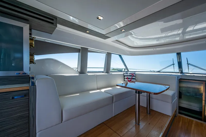  Yacht Photos Pics Luxurious interior of 2020 Tiara Yachts C44 Coupe with elegant seating and panoramic windows.