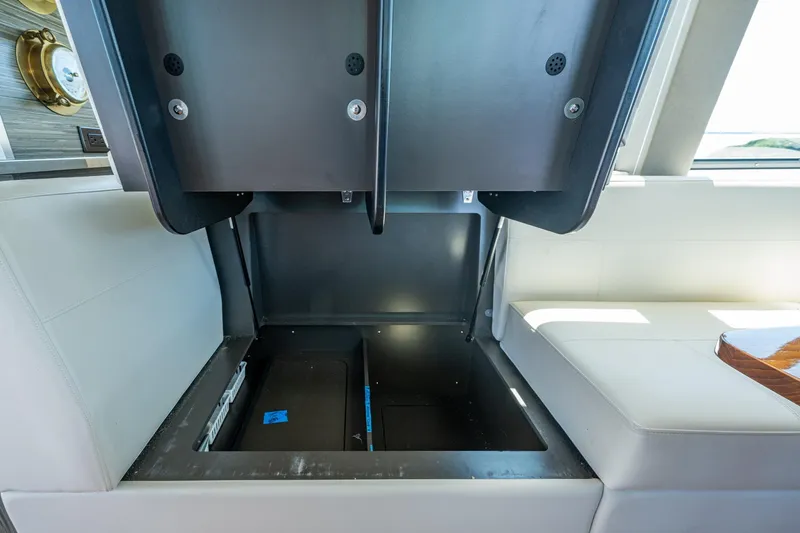  Yacht Photos Pics 2020 Tiara Yachts C44 Coupe interior storage compartment with open hatch.