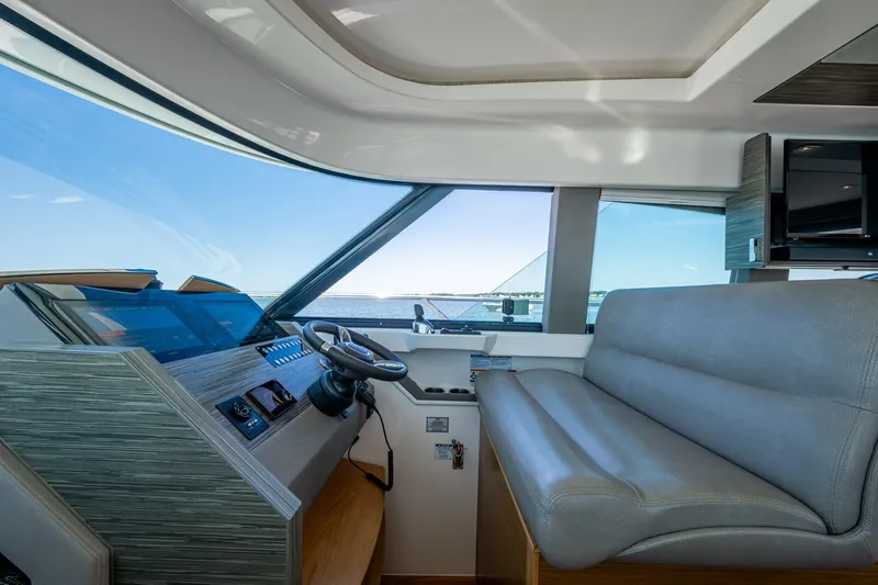  Yacht Photos Pics 2020 Tiara Yachts C44 Coupe interior with helm and seating, overlooking the ocean.