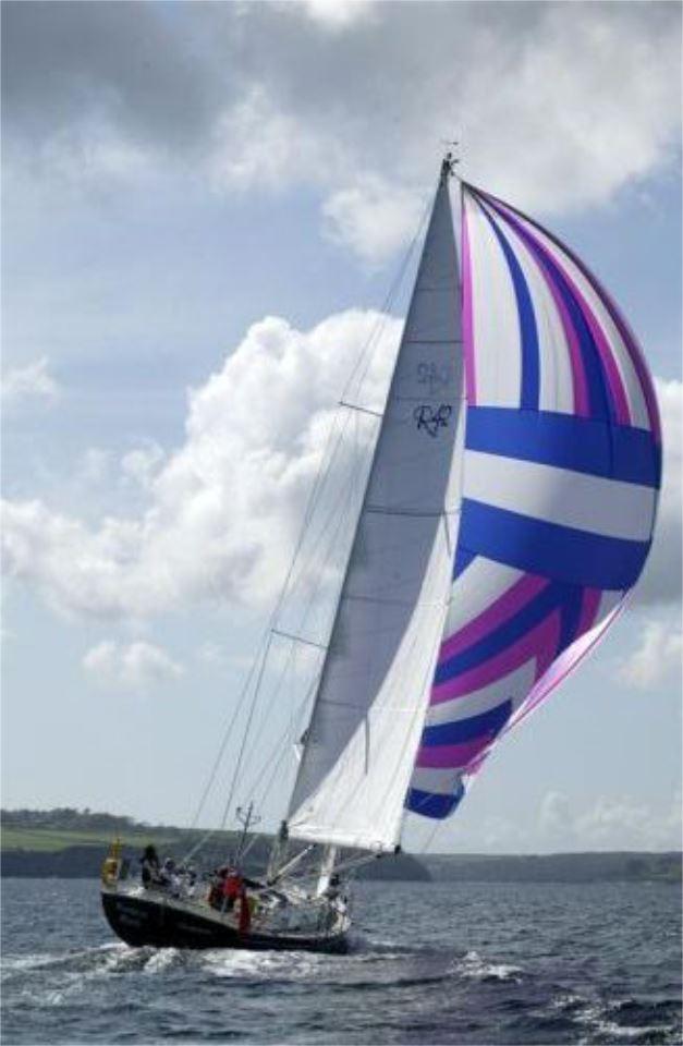 Sailing yacht Rustler 42 (2025) with colorful spinnaker on open water.