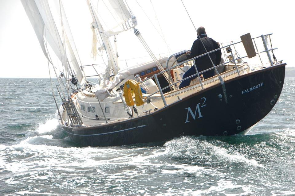 Sailing yacht Rustler 42, 2025 model, navigating ocean waves with full sails.