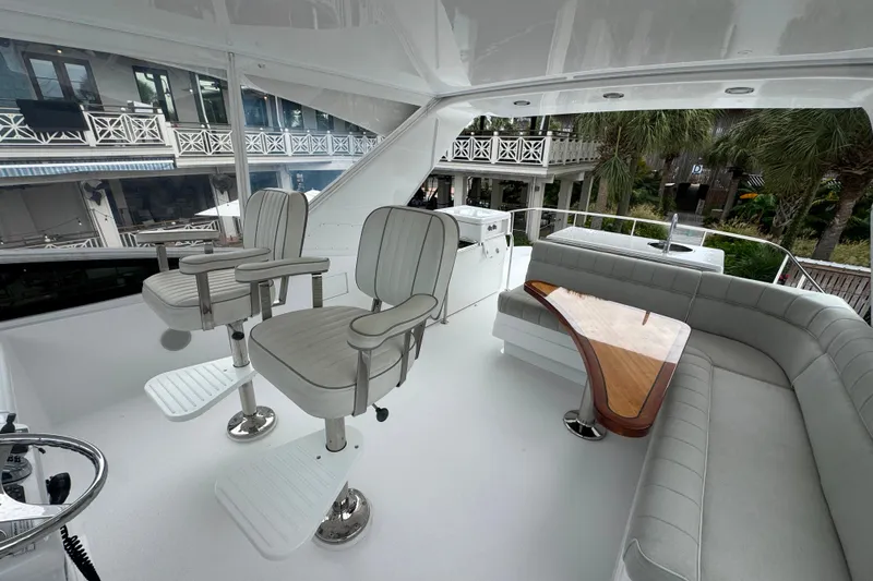 Elsewhere Yacht Photos Pics 2013 Hatteras 60 Motor Yacht interior with seating, helm chairs, and table.