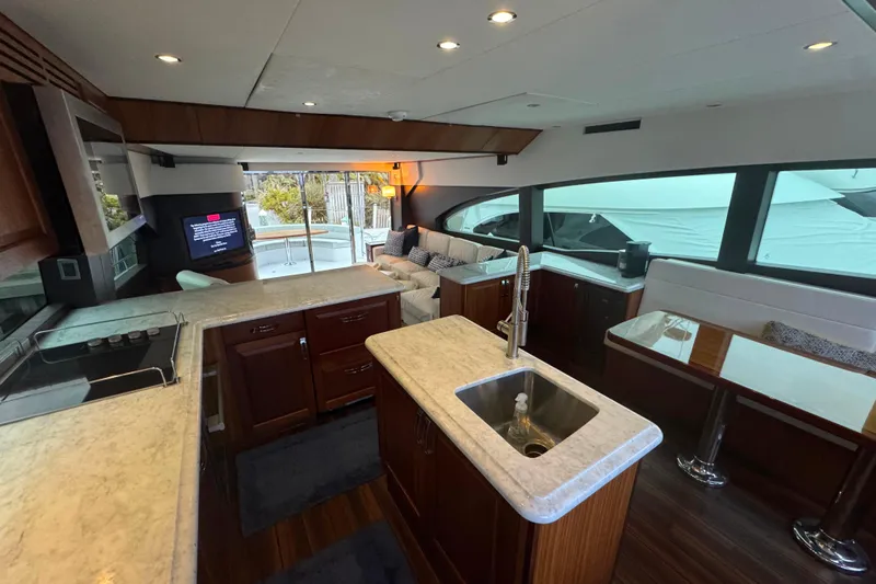 Elsewhere Yacht Photos Pics Interior of 2013 Hatteras 60 Motor Yacht with modern kitchen and seating area.