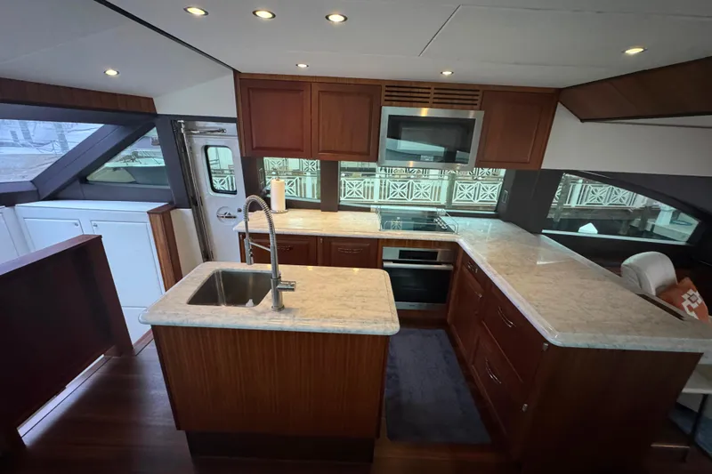 Elsewhere Yacht Photos Pics Luxurious kitchen interior of 2013 Hatteras 60 Motor Yacht with modern appliances.