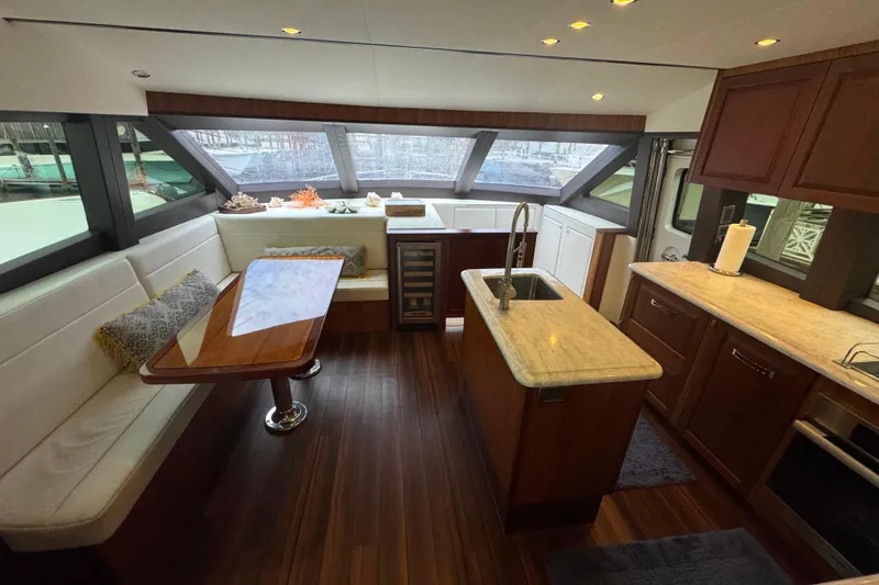 Elsewhere Yacht Photos Pics Luxurious interior of 2013 Hatteras 60 Motor Yacht with modern kitchen and dining area.