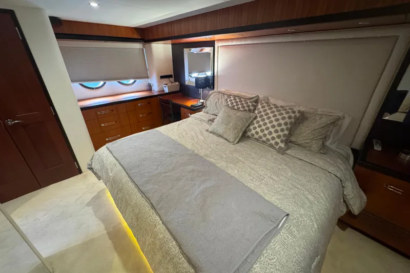 Elsewhere Yacht Photos Pics Luxurious bedroom interior of 2013 Hatteras 60 Motor Yacht with elegant bedding and wood accents.