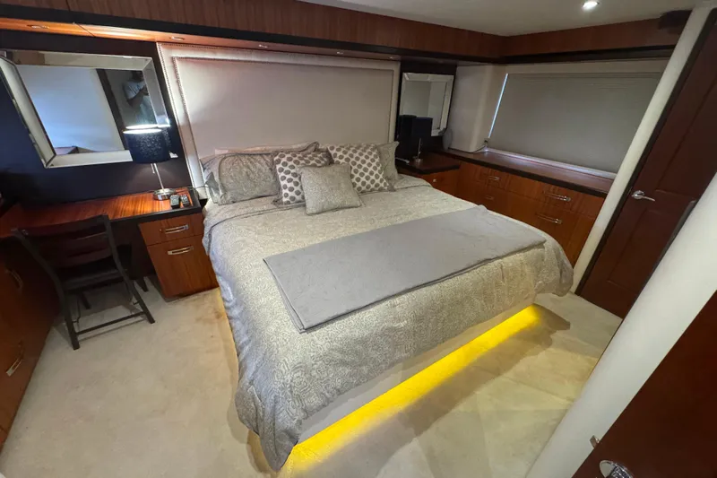 Elsewhere Yacht Photos Pics Luxurious bedroom interior of 2013 Hatteras 60 Motor Yacht with elegant bedding and ambient lighting.